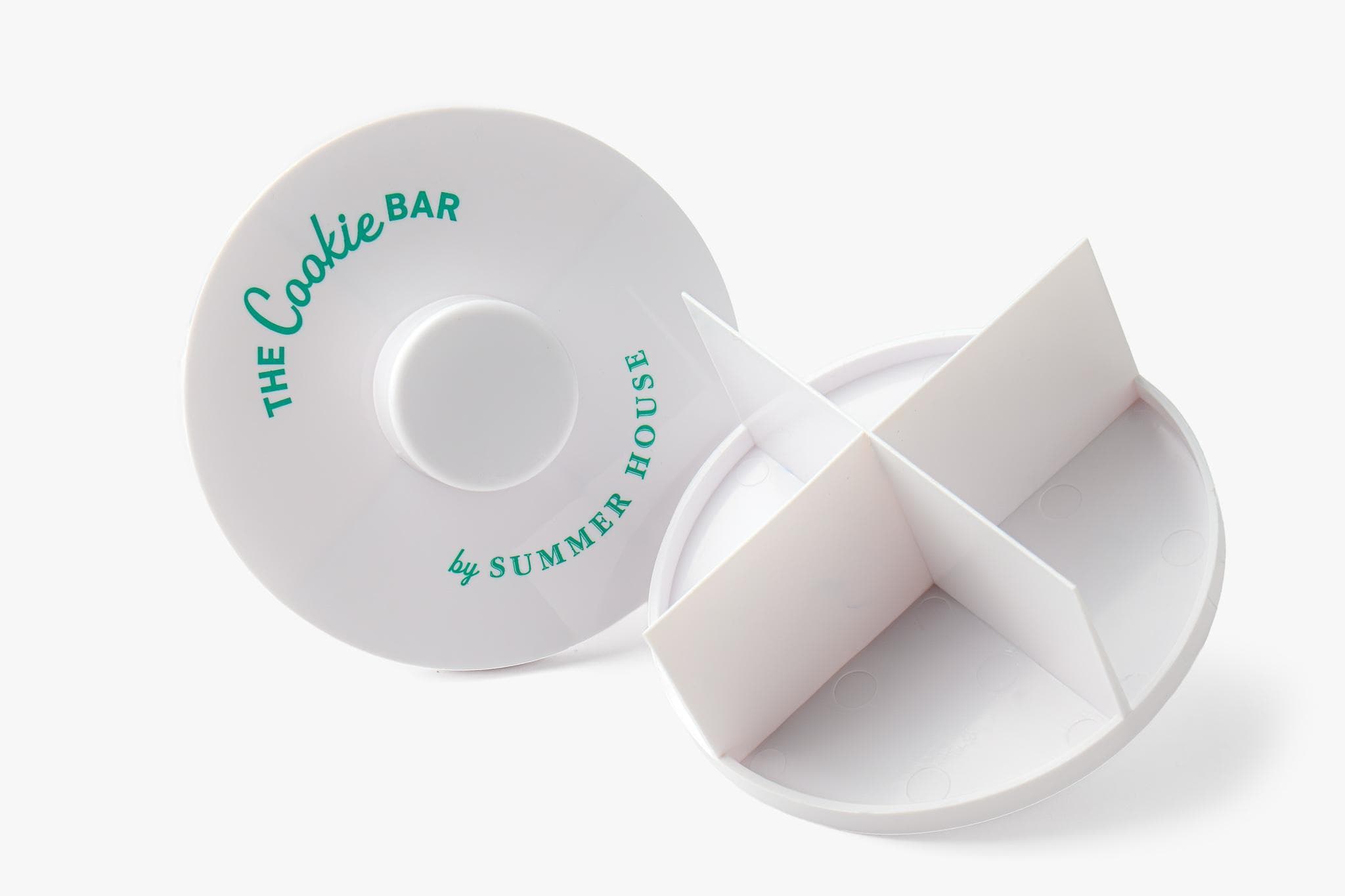 A circular device with sharp edges, designed to cut a cookie into four equal pieces.